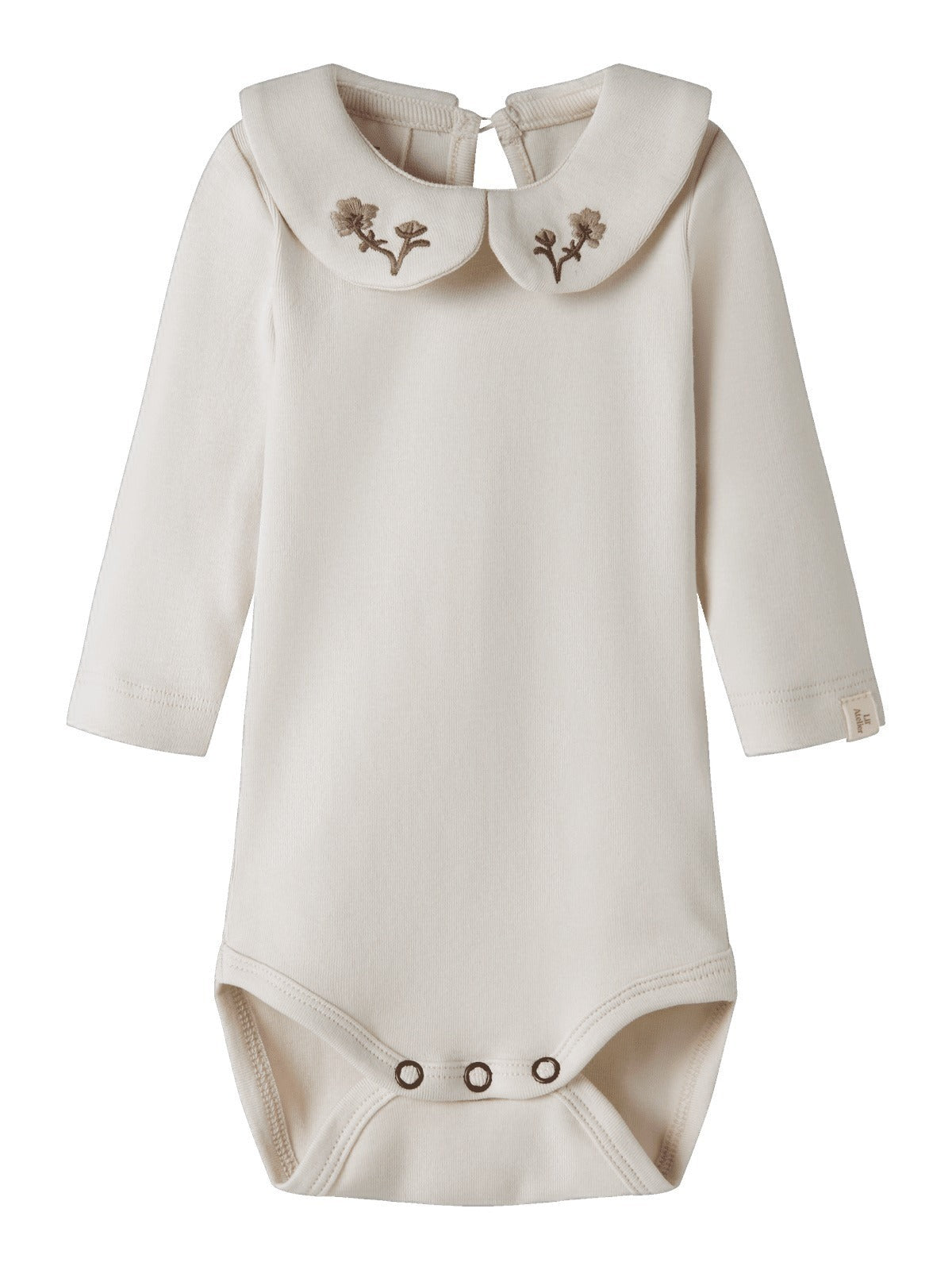 Beige langermet body med rund krage og brodert blomst, sett forfra